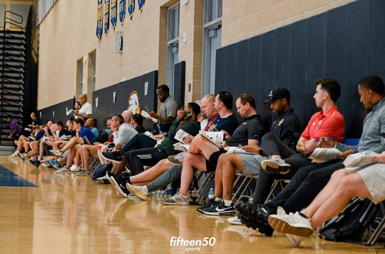 College coaches watching games from the bleachers at an NCAA certified event